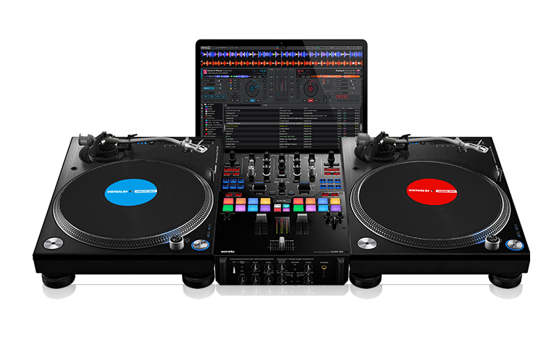 VirtualDJ on a laptop between two decks and a mixer